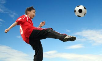 teen-boy-kicking-soccer-ball